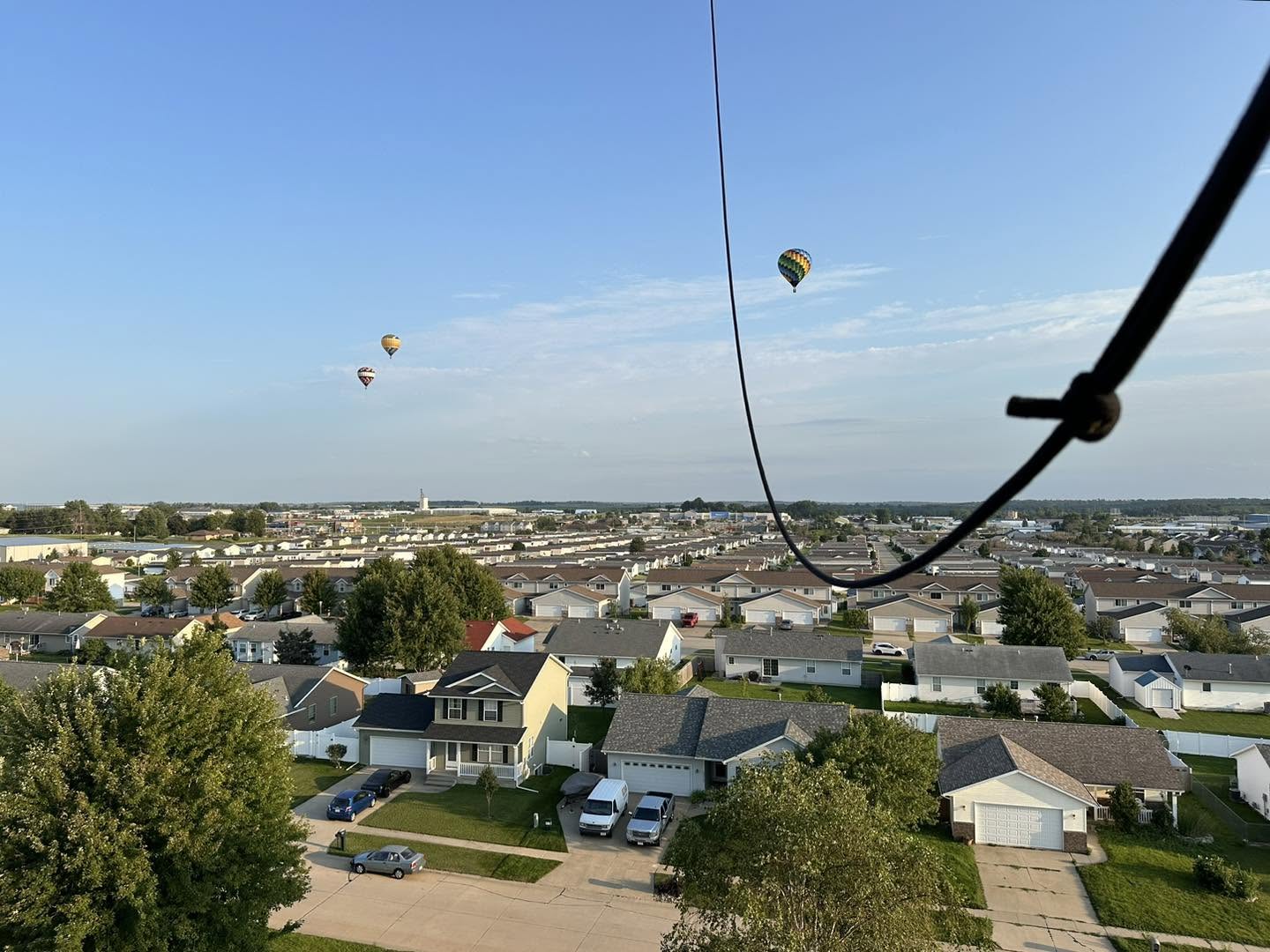 Hot air balloons flying over the neighborhood during the anniversary flight
